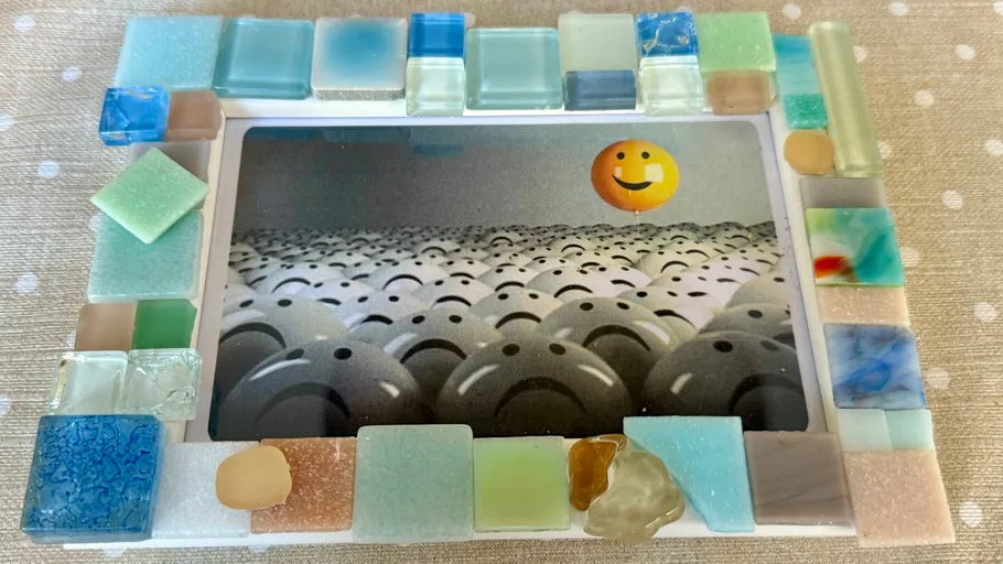 Colorful tiled frame with smiling balloon photo.