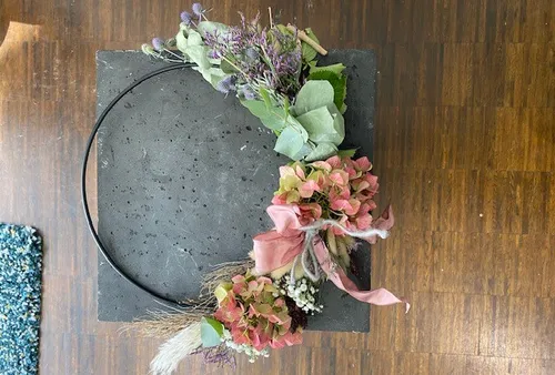 Floral wreath on a stone surface.