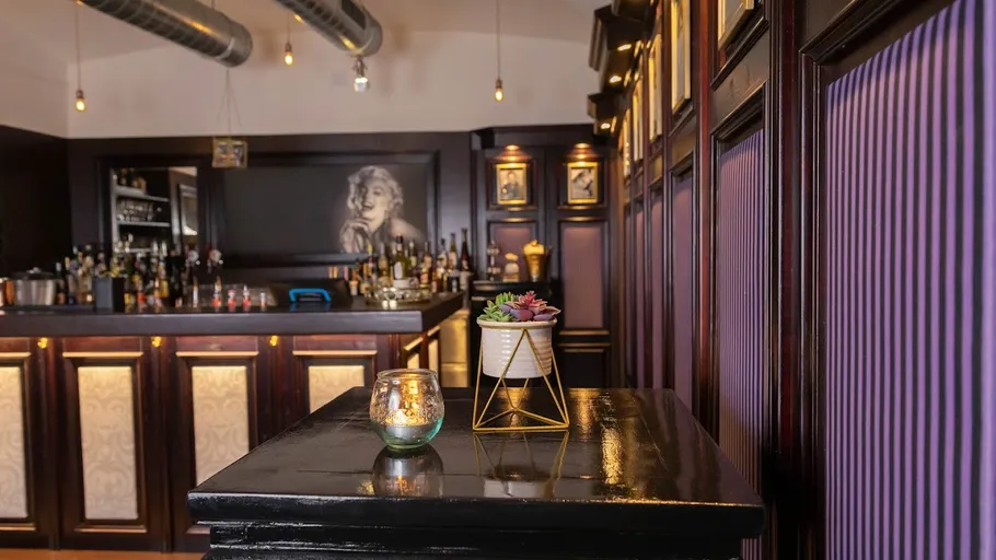 Elegant bar interior with purple accents.