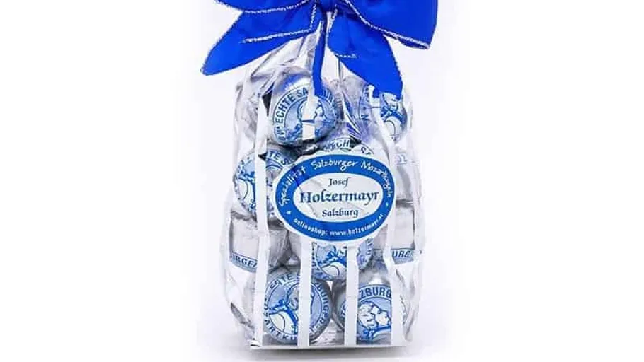 Bag of chocolates with blue bow packaging.