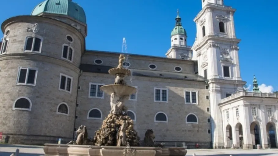 Baroque fountain in front of historic building.