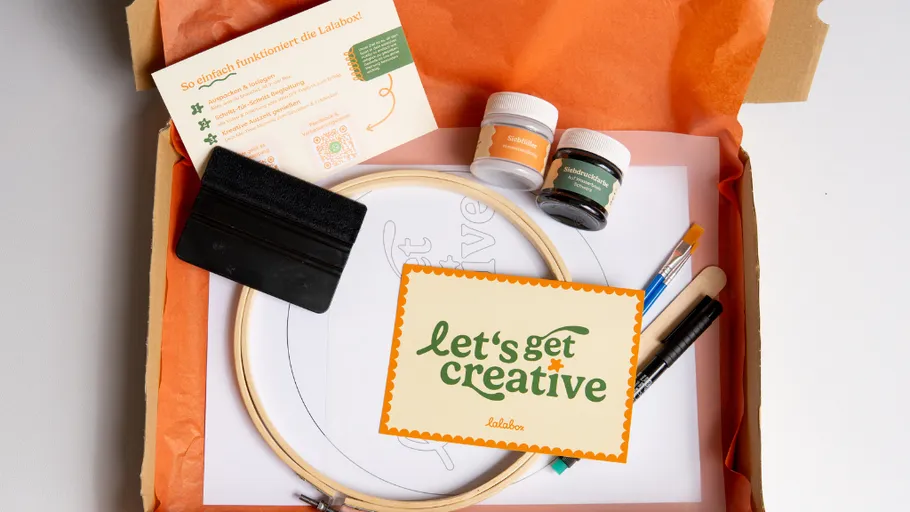 Craft kit with paints, brushes, and instructions.