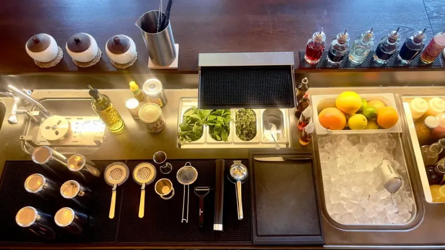 Bar setup with tools and ingredients organized.