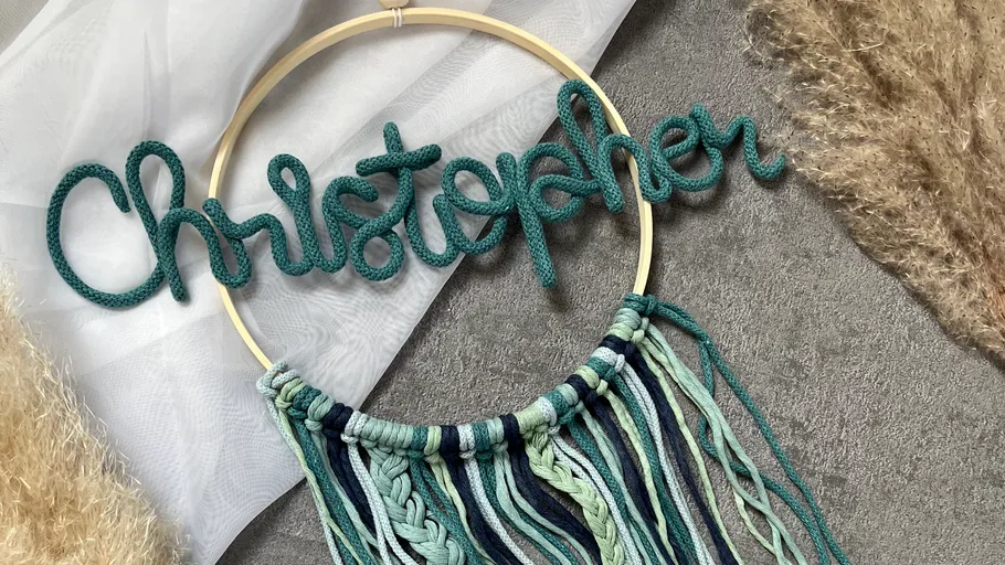 Name sign of woven yarn on round frame.