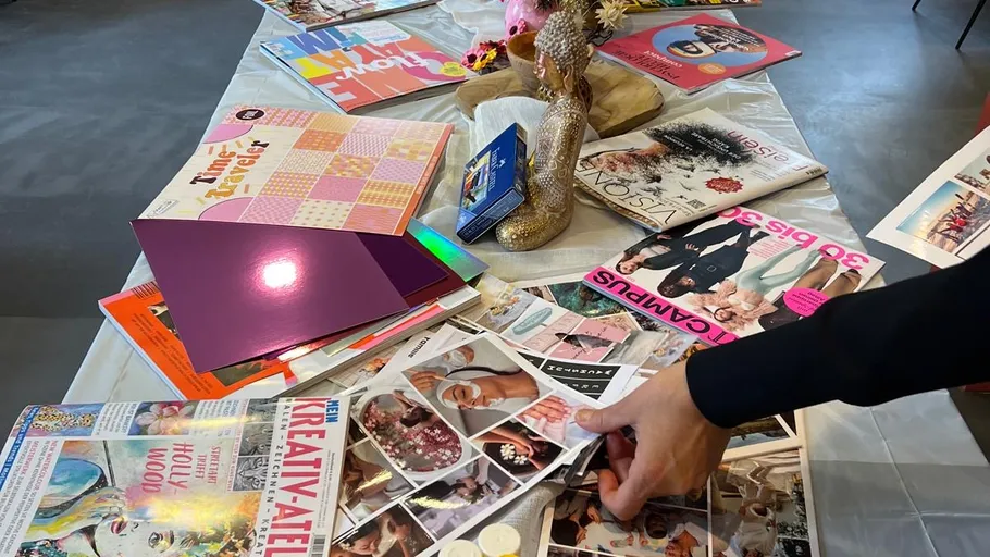 Hand sortiert Zeitschriften auf unordentlichem Tisch.