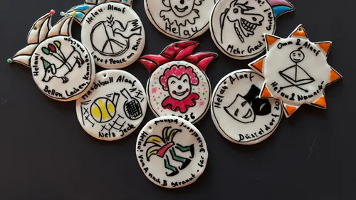 Colorful badges with various carnival designs.