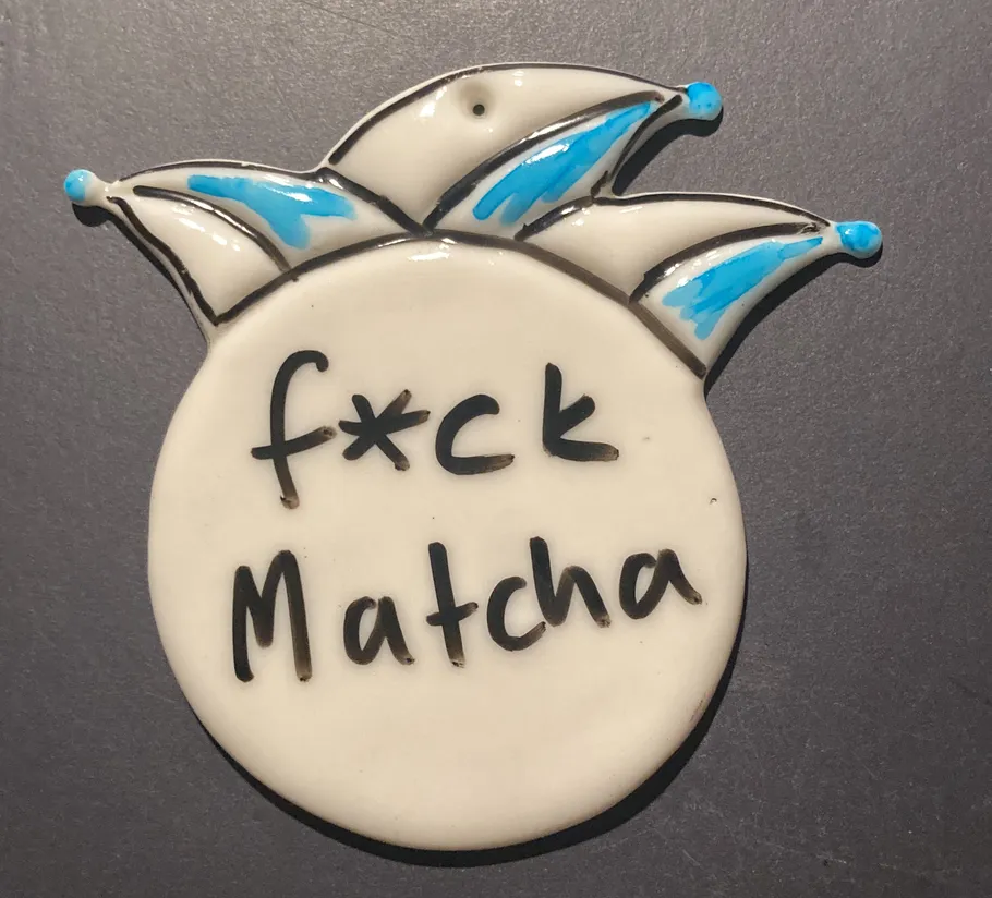 Ceramic piece with edgy text and crown design.