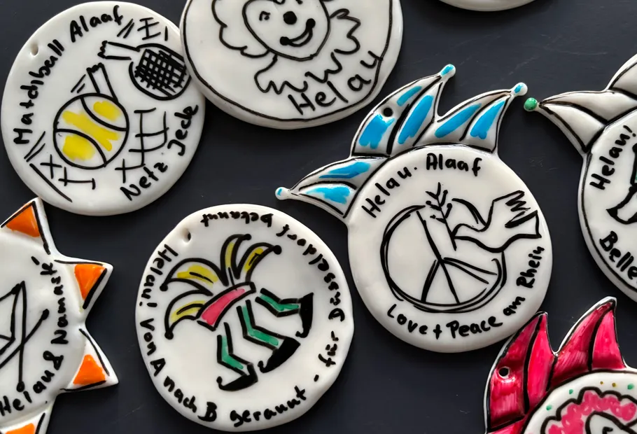 Colorful carnival badges with drawings and text.