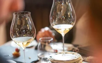 Wine glasses on a dining table.