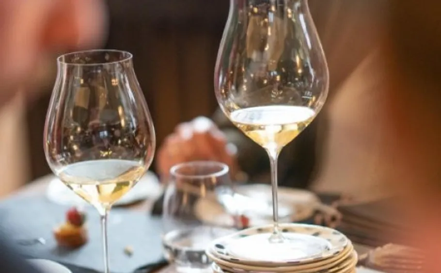 Wine glasses on a dining table.