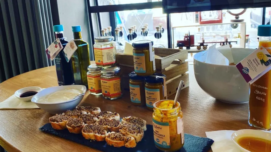Tasting spread with sauces and breads on table.