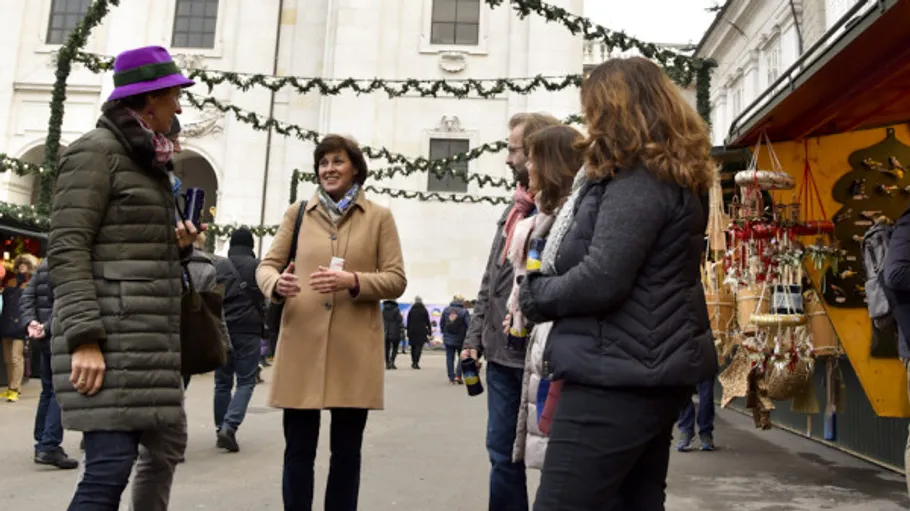 Group of people talking at Christmas market.
