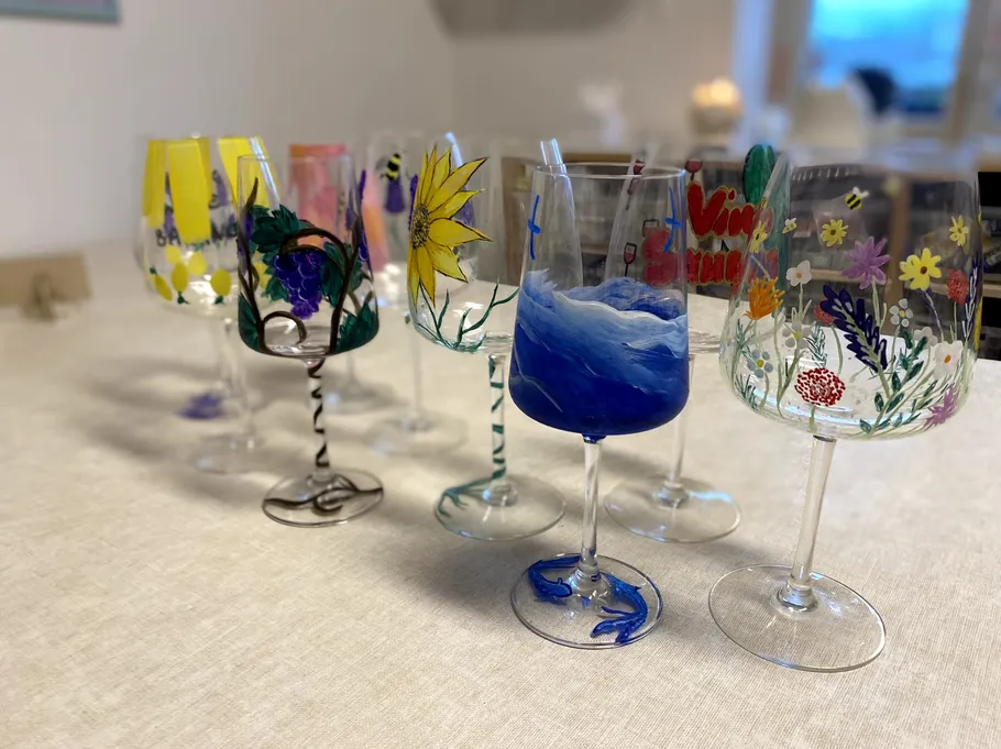 Decorated wine glasses on a table.