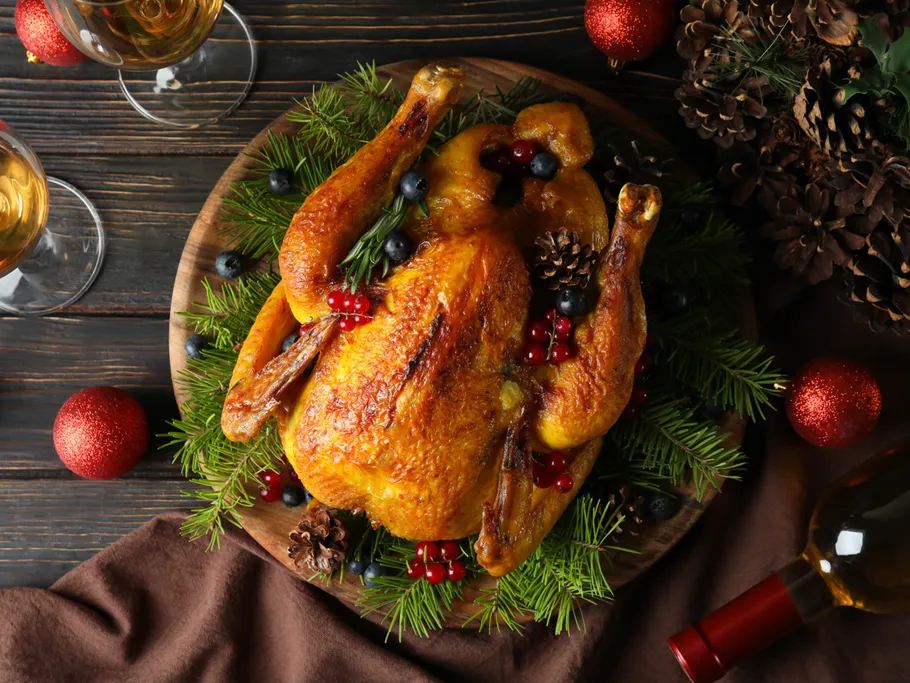 Baked chicken with holiday decoration on a table.
