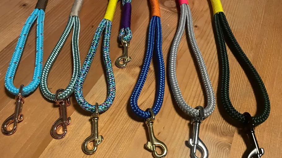 Colorful dog leashes displayed on a table.