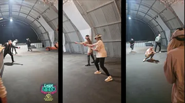 People in VR headsets playing a game indoors.