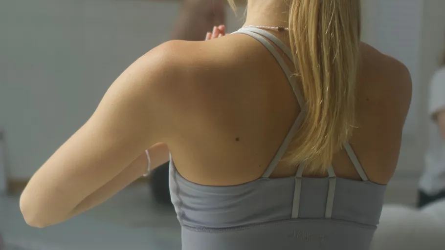 Woman in yoga pose, indoor setting.