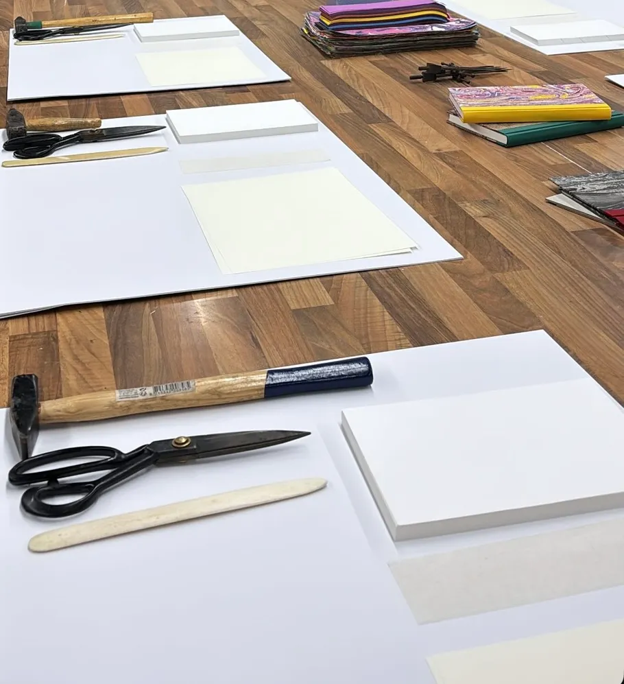Craft tools on wooden table organized neatly.