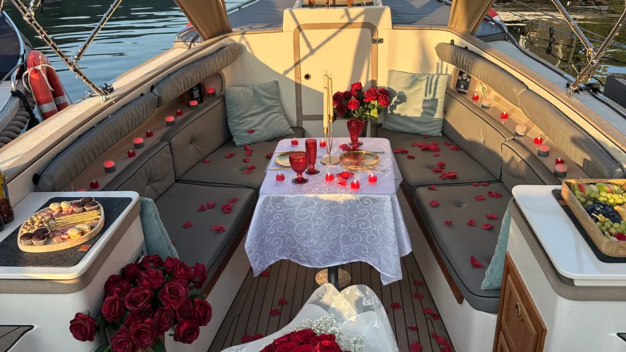 Romantic boat setup with roses and candles.