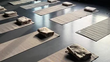 Yoga mats and blankets arranged indoors.