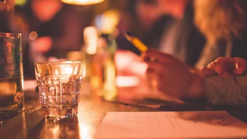 Glass on table with blurred background.