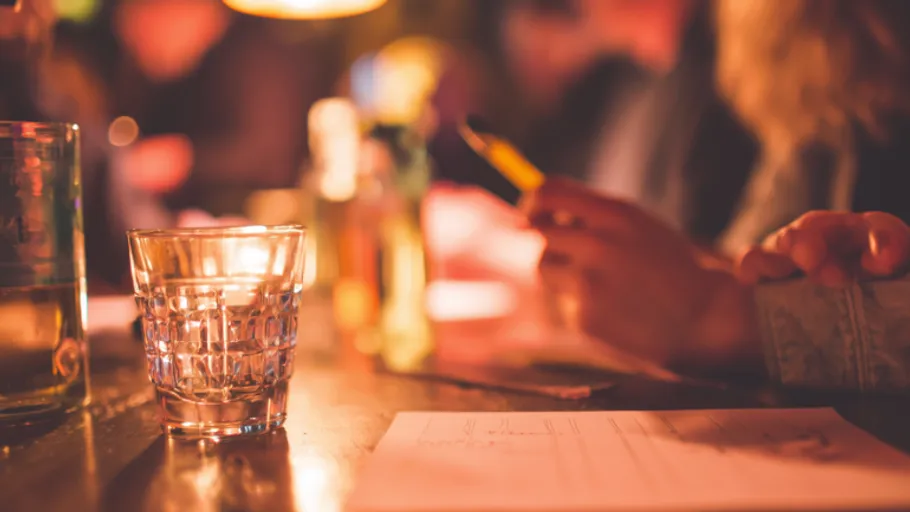Glass on table with blurred background.