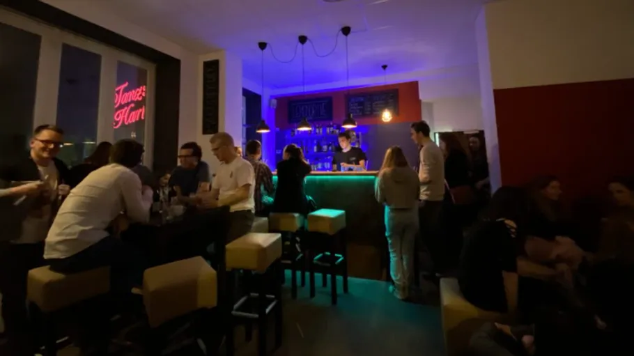 People socializing in a dimly lit bar.