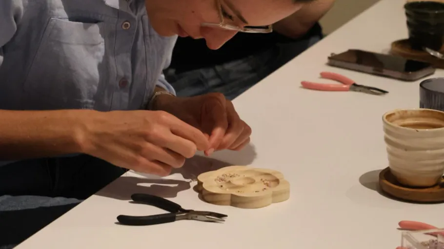 Person crafting at table with tools.