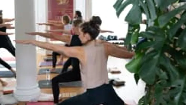 People practicing yoga in a studio.