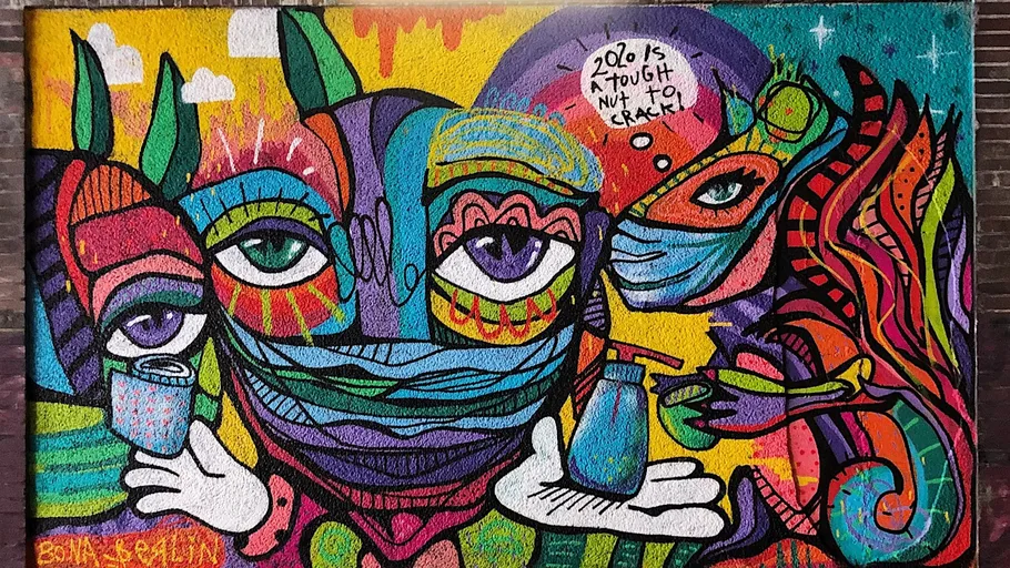 Colorful mural with abstract faces and masks.