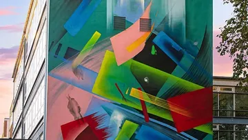 Colorful abstract mural on a building exterior.