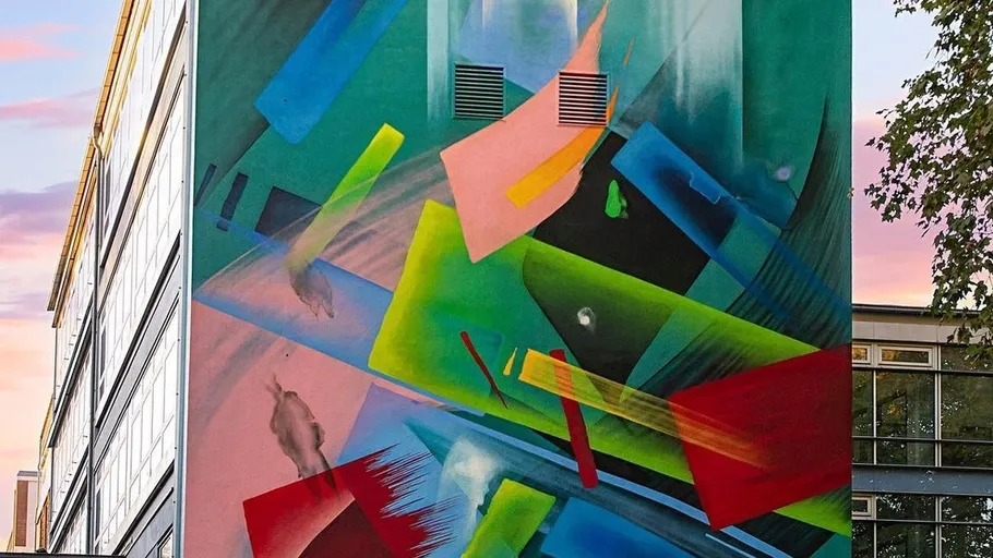 Colorful abstract mural on a building exterior.