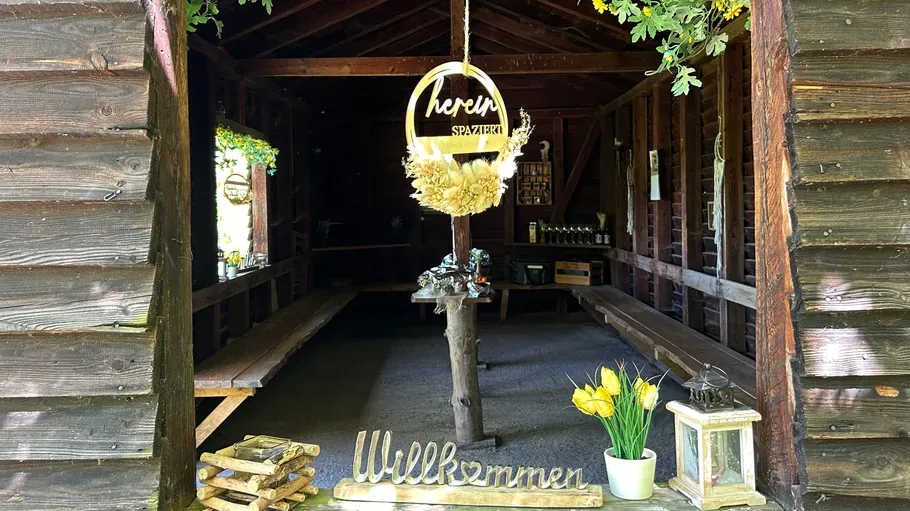 Wooden cabin entrance with welcoming decor.