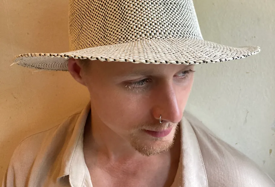 Person wearing hat with neutral expression indoors.