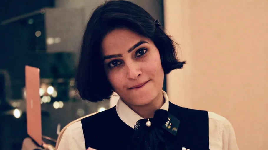 Person wearing uniform, with thoughtful expression indoors.