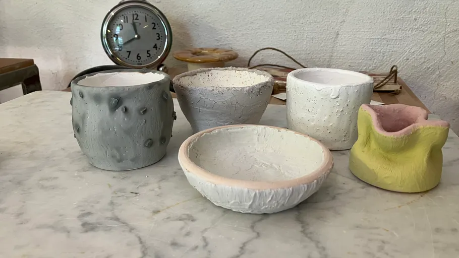 Five handmade ceramic bowls on a table.