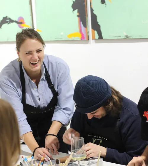 People laughing and crafting at a table.
