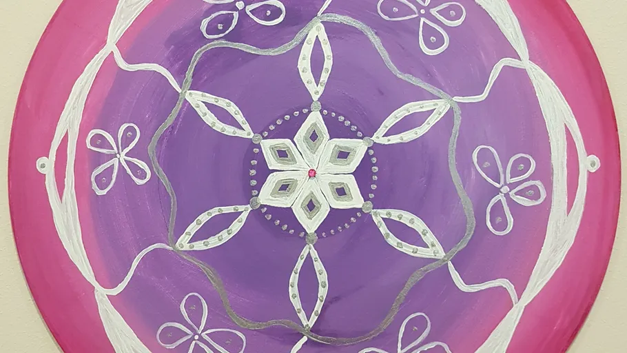 Colorful mandala with floral patterns, circular design.