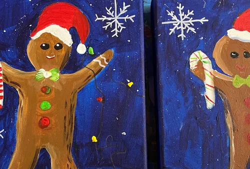 Gingerbread figures hold candy canes, wearing Santa hats.