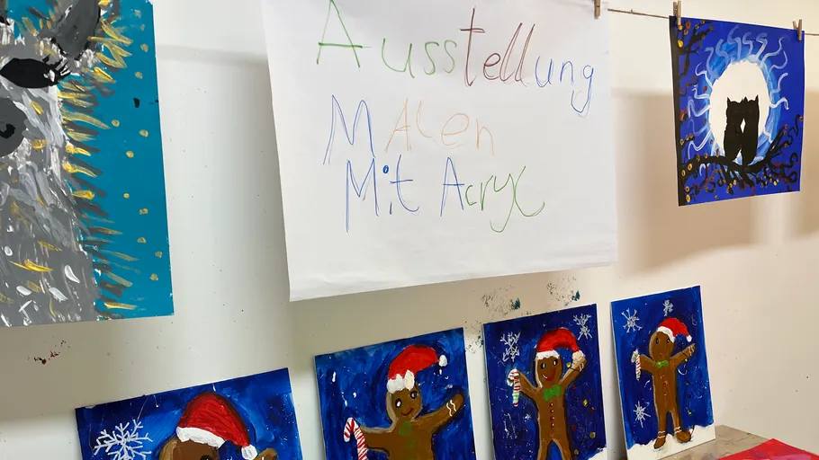 Paintings of animals and gingerbread figures displayed.