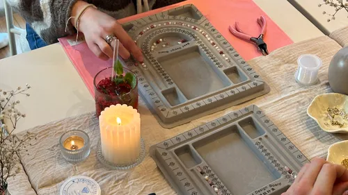 People making jewelry using bead boards.