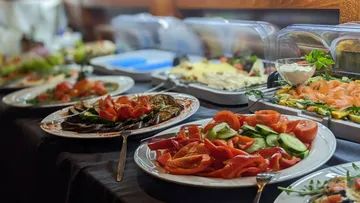 Buffet with various salads and food displayed.