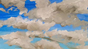 Clouds painted on a blue sky canvas.