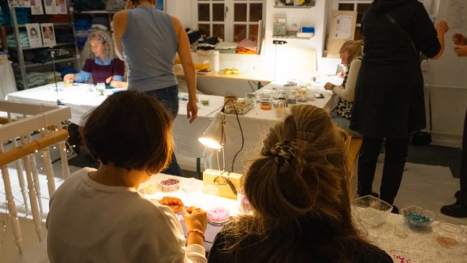 People making crafts in a cozy room.