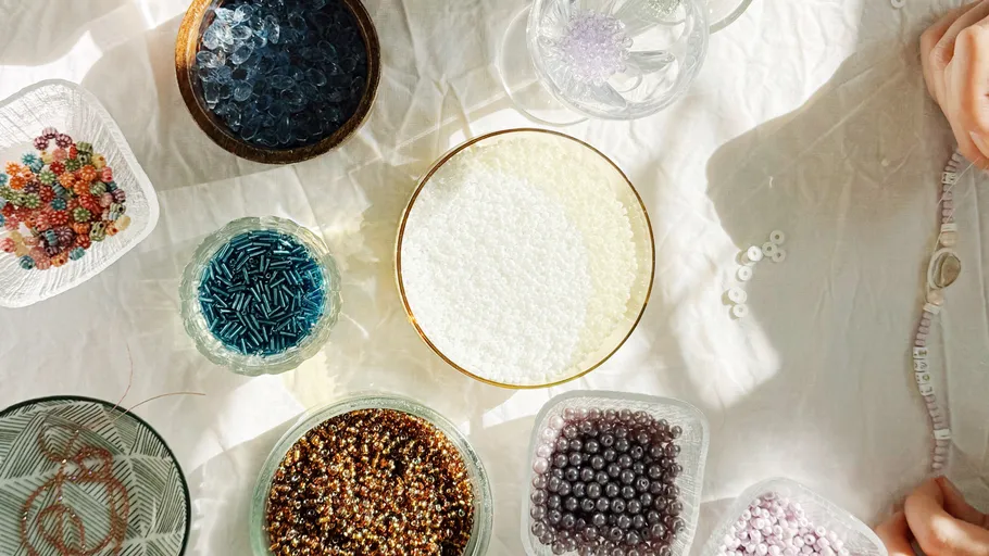 Colorful beads arranged on a white table.