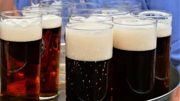 Glasses of beer on a serving tray.