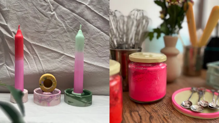 Bunte Kerzen auf Ständern neben Gläsern.