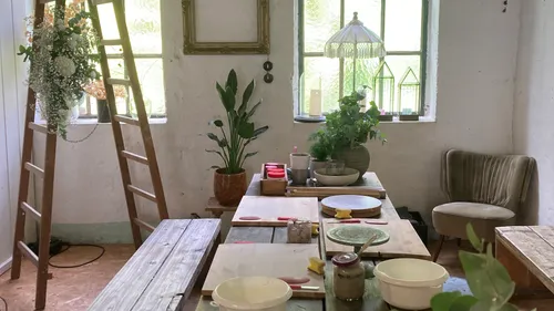 Rustic kitchen with table and ladder.