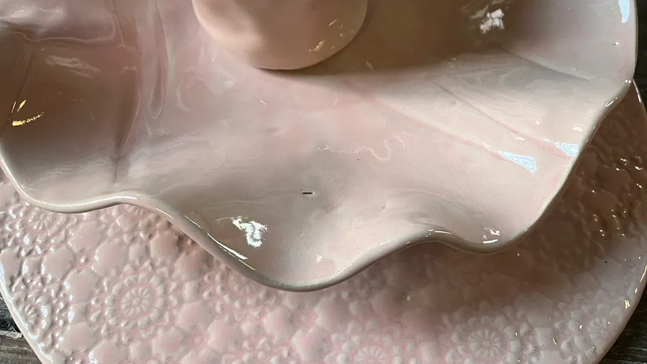 Pink decorative plates with floral patterns.