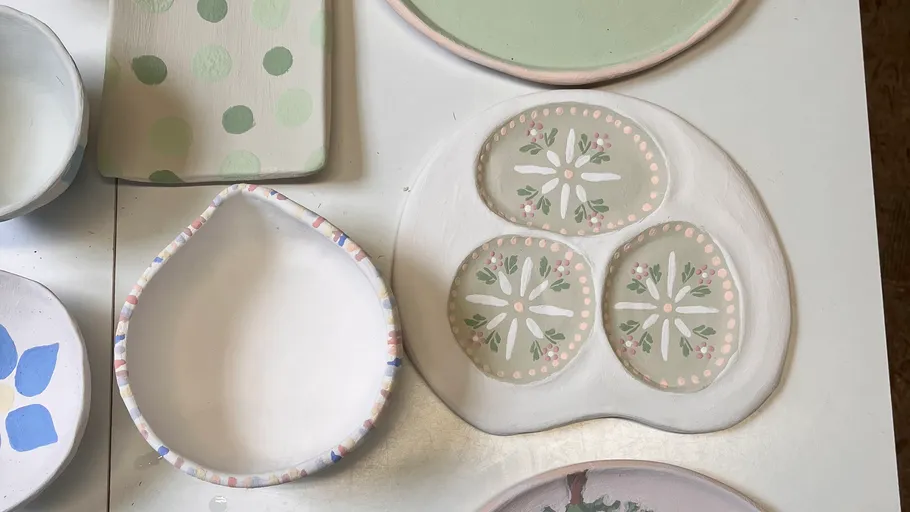 Colorful ceramic plates on a white table.